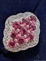 Top view showing cluster of pink CZ stones and pavé clear CZ border