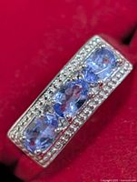 Close-up of tanzanite stones and milgrain border on ring top