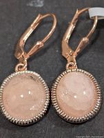 front view of both earrings showing cabochon morganite and rope bezel