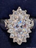 Top view of silver ring showing marquise center CZ and halo of round CZ stones