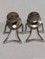 front view of both earrings showing disc fronts and open figure outline