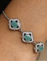 Bracelet on wrist showing three emerald-color CZ stations