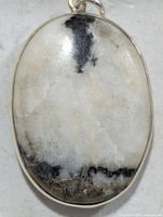 Front view of silver pendant showing stone pattern