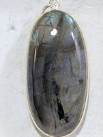 Front view of oval labradorite pendant in silver bezel