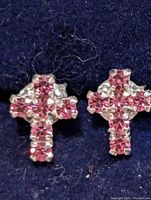 Front view of both cross earrings showing pink stones and silver setting