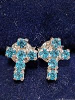 Close-up of both earrings in case showing gemstone arrangement