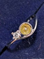 Top view showing clear stone and empty bezel setting on silver-tone ring