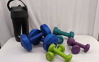 All dumbbells and Nike bottle grouped