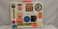 Front view of Fisher-Price activity center showing all interactive features and carry handle
