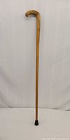 Full view of walking cane showing overall length, handle and tip