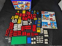 Complete layout of 175 LEGO pieces, green baseplate, box and minifigure parts