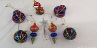 Group of seven blown glass ornaments on cloth background