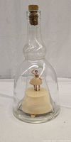 Full view of glass decanter with ballerina and cork