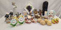 Group view of all ceramic novelty shakers, figurines, and wall plaque