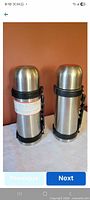 Two stainless steel vacuum bottles side by side, full view