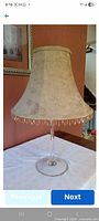 Full view of chenille lamp shade on glass stand