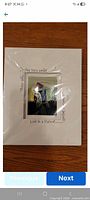 Front view of sealed artwork showing mat, abstract image and quote
