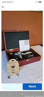 Open wooden box showing corkscrew set and packaged wine glass charms