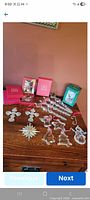 Overview of loose clear glass ornaments and boxed pieces on wooden surface