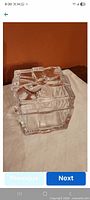clear glass box with lid closed showing bow design