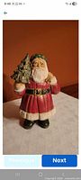 Front view of painted ceramic Santa figurine