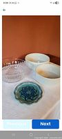 Group shot of two ceramic dishes, glass bowl and pottery dish