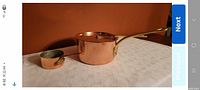 Both copper pots side by side showing relative sizes and handles