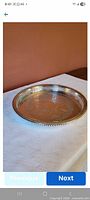 Angled top view showing etched center, pierced rim, rope edge
