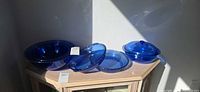 All five cobalt blue Pyrex pieces on cabinet