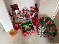 Overall lot showing village buildings, wreath, crackers, plush toys, linens and accessories
