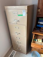 Full view of beige Cole steel file cabinet next to desk