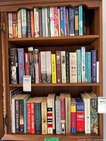 Full view of three of the four book shelves showing quantity and variety of titles