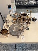 Overall view of all silver-plate items on table