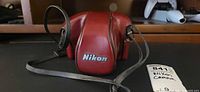 Red Nikon leather camera case, closed view
