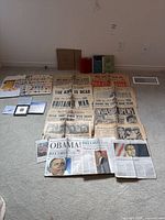 Overview of newspapers spread on floor with stamp albums and sheets