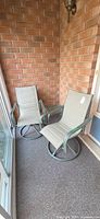 Two swivel patio chairs on balcony
