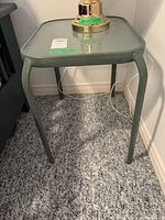 Front view of green square outdoor side table with plexiglass top