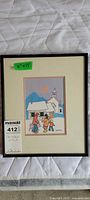 Full view of framed Ted Harrison print with lot tag visible
