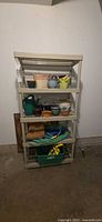 Front view of beige five-tier plastic utility shelf with contents (contents excluded)