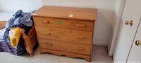 Front view of Vilas pine dresser showing three drawers, pulls, scalloped base