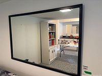 Full view of rectangular mirror hung on wall