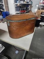 Full view of copper washtub with lid on table
