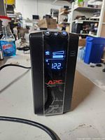 Front view showing APC Back-UPS 1000 powered on with LCD display