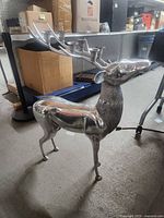 Full side view of polished cast aluminum deer candelabra