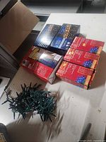 Stacked boxed light sets and loose coiled strand on table