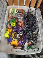 Open tote showing spiders, string lights, small pumpkins