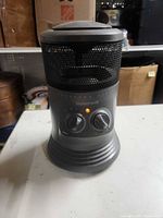 Front view showing brand, control knobs and mesh grille