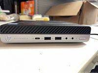 Front view showing HP EliteDesk branding, USB-C, USB-A ports, audio jacks, power button