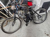 Full side view of black Huffy bicycle with engine kit installed