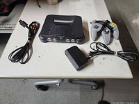 Console, controller, AV cable, power adapter on table
